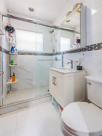 a bathroom with a sink a toilet and a shower