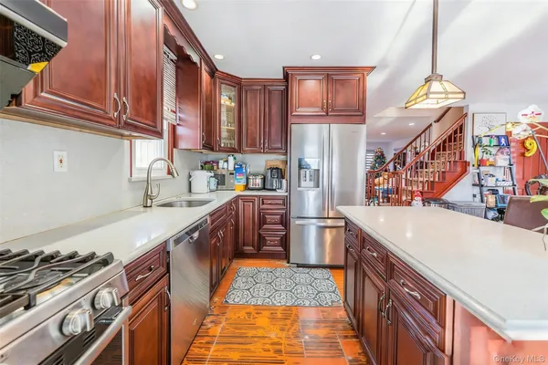 a kitchen with stainless steel appliances granite countertop a sink and a stove