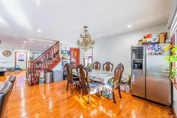 a dining room with furniture entryway and wooden floor