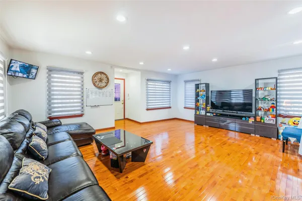 a living room with furniture pool and a flat screen tv