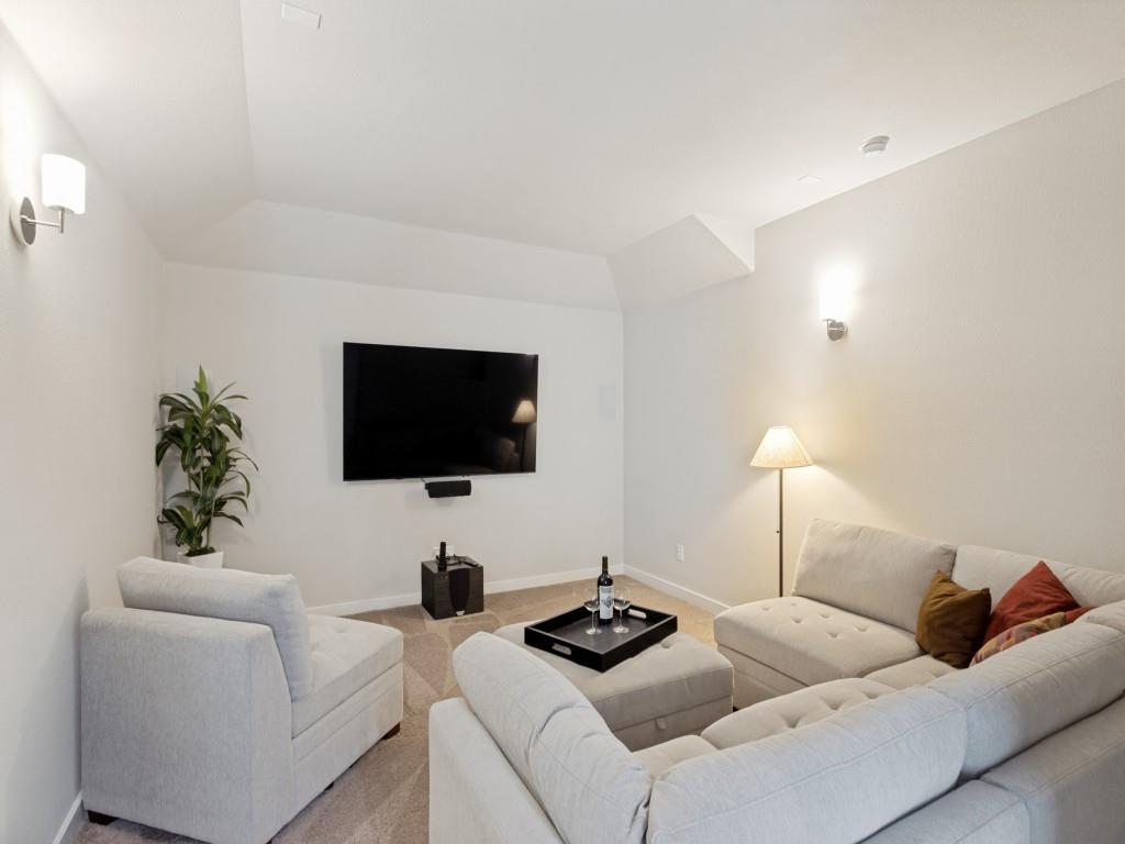 10613 Smiths Bnd Road Fort Worth, TX 76126 - Photo 12 of 29 Carpeted media room featuring a mounted flat-screen television, built-in sound bar, two wall-mounted sconces, and recessed ceiling lighting