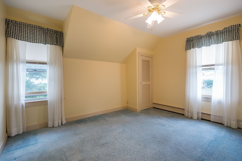 8 Spring Lane Stoneham, MA 02180 - Photo 13 of 21 an empty room with chandelier fan and windows