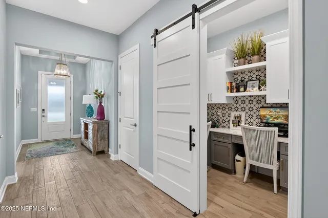 a view of a garden with plants and large trees