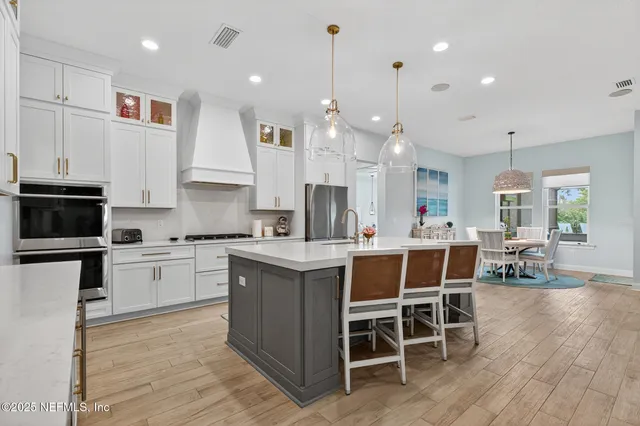 an aerial view of residential houses with outdoor space and ocean view
