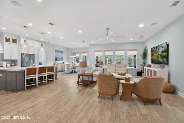 an aerial view of residential houses with outdoor space and ocean view