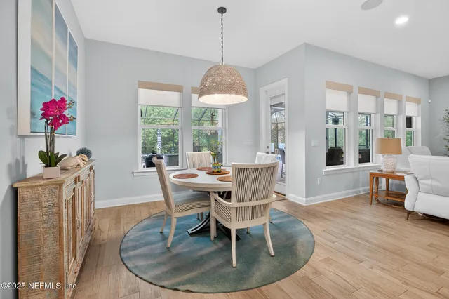 an aerial view of residential houses with outdoor space and ocean view