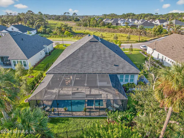 a dining room with furniture a chandelier and wooden floor