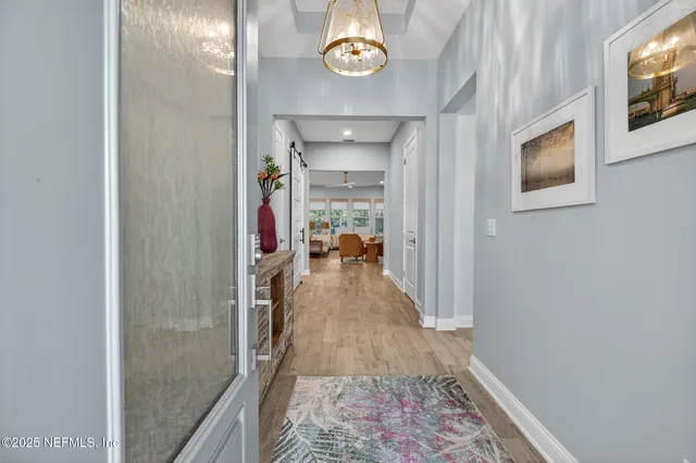 a kitchen with stainless steel appliances a sink dishwasher and cabinets with wooden floor