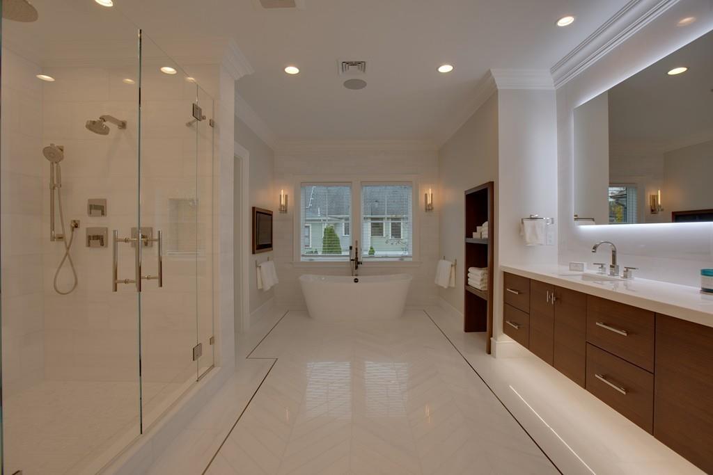 32 Forest Street Lexington, MA 02421 - Photo 14 of 23 a bathroom with a glass shower door and a sink