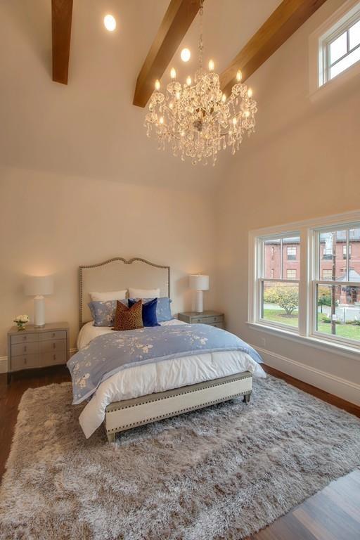 32 Forest Street Lexington, MA 02421 - Photo 17 of 23 a bedroom with a large bed and a chandelier