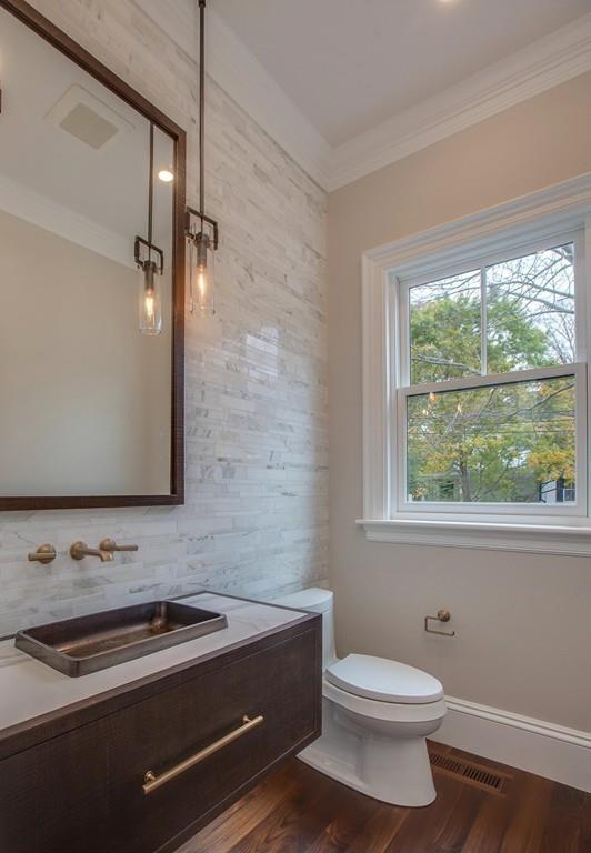 32 Forest Street Lexington, MA 02421 - Photo 19 of 23 a bathroom with a sink a toilet and a window