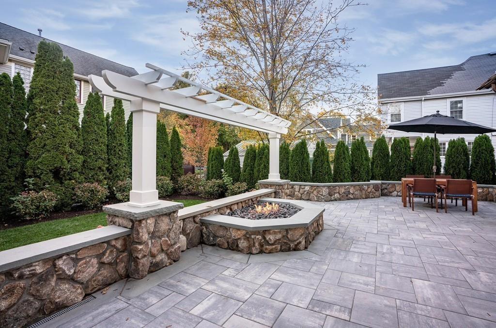 32 Forest Street Lexington, MA 02421 - Photo 23 of 23 a view of a patio with a dining table and chairs with a couches near a garden