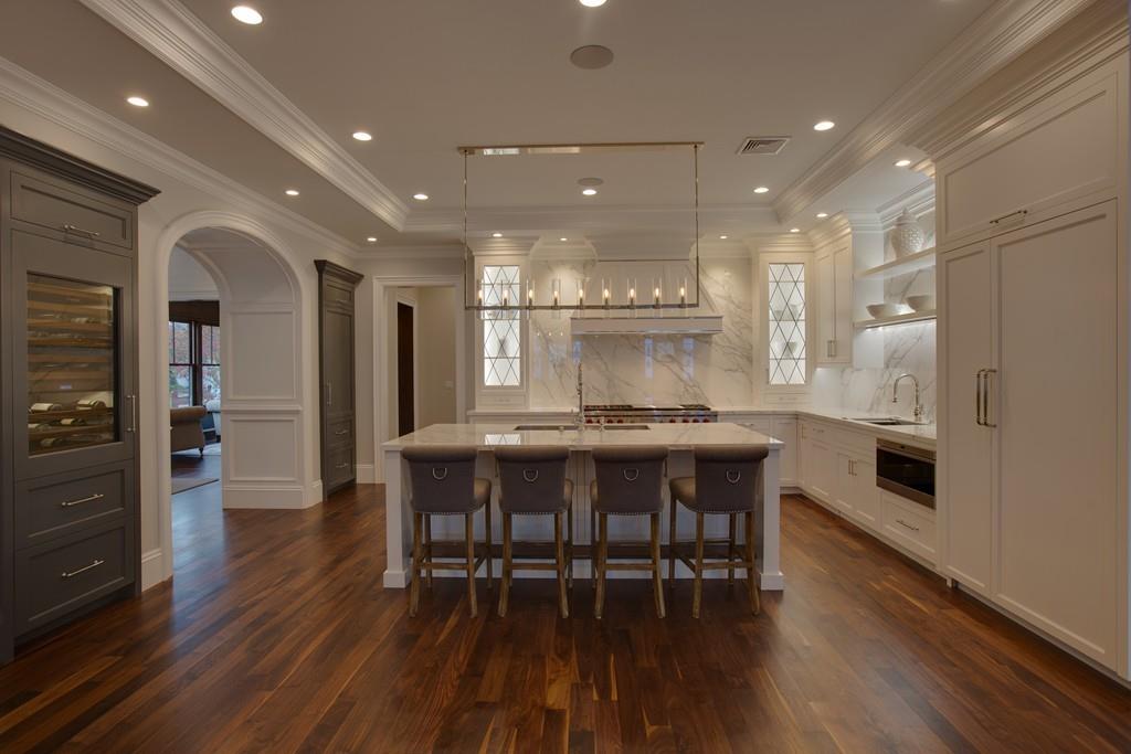 32 Forest Street Lexington, MA 02421 - Photo 4 of 23 a kitchen with stainless steel appliances granite countertop a table chairs refrigerator and sink