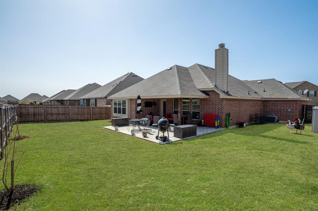 3724 Ranchers Ridge Krum, TX 76249 - Photo 26 of 32 Vast backyard featuring a grassy area perfect forplay and recreation!