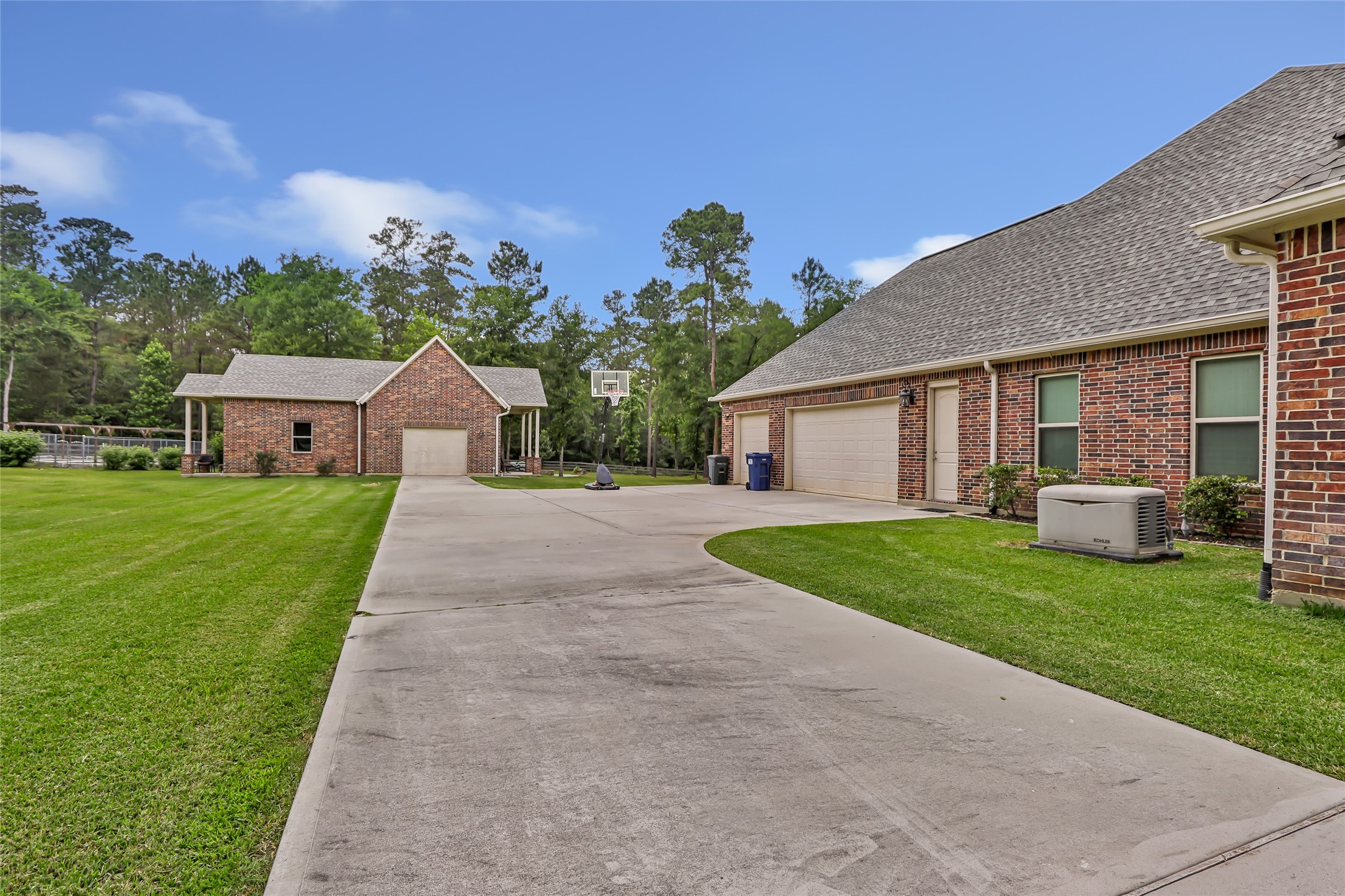 229 Sundog Road Huntsville, TX 77340 - Photo 5 of 50 3 car attached garage plus the bonus detached building can be built out for a workshop, guest house, extra garage. It is plumbed for a bathroom and has electricity!