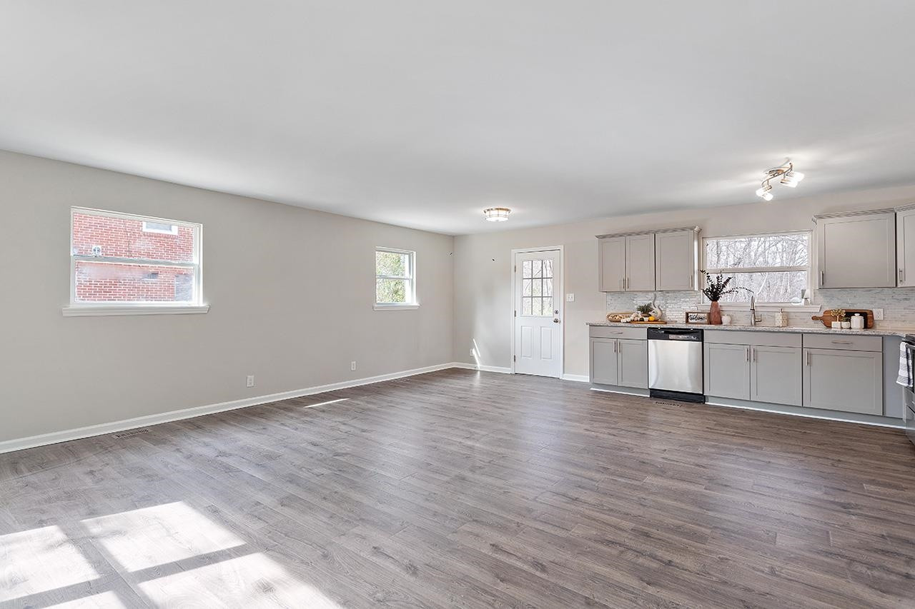 1101 Springdale Drive Durham, NC 27707 - Photo 2 of 24 a view of a kitchen with wooden floor and windows