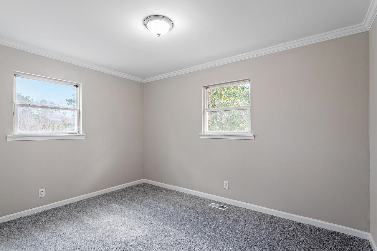 1101 Springdale Drive Durham, NC 27707 - Photo 22 of 24 an empty room with windows