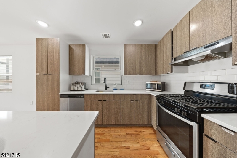735 Seaport Drive, Unit 2 Elizabeth, NJ 07201 - Photo 14 of 28 a kitchen with stainless steel appliances granite countertop a sink stove and refrigerator