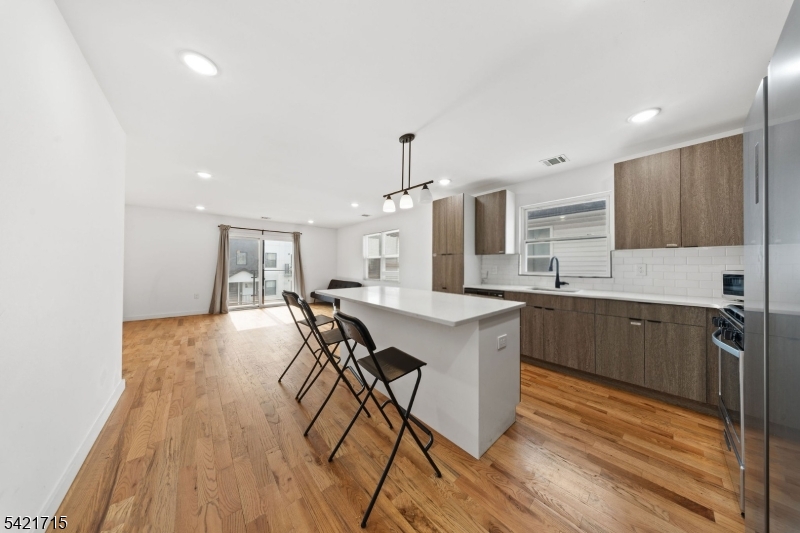 735 Seaport Drive, Unit 2 Elizabeth, NJ 07201 - Photo 15 of 28 a kitchen with stainless steel appliances a table and chairs in it