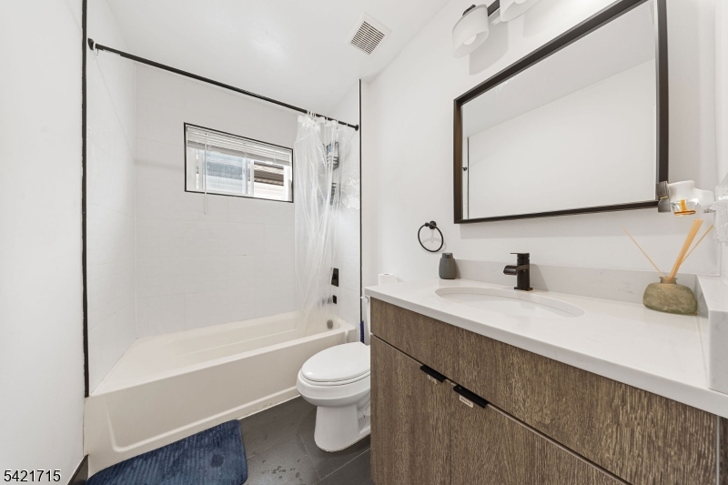 735 Seaport Drive, Unit 2 Elizabeth, NJ 07201 - Photo 17 of 28 a bathroom with a granite countertop sink toilet and mirror