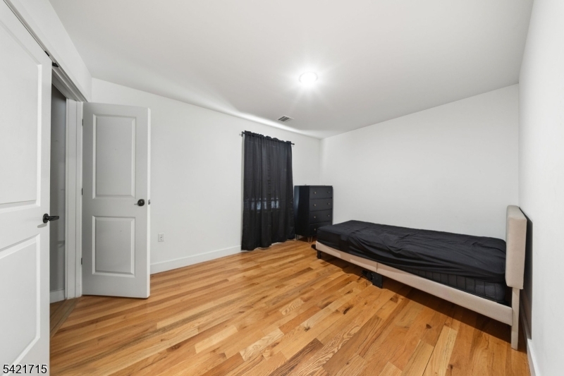 735 Seaport Drive, Unit 2 Elizabeth, NJ 07201 - Photo 25 of 28 a bedroom with a bed and a dresser