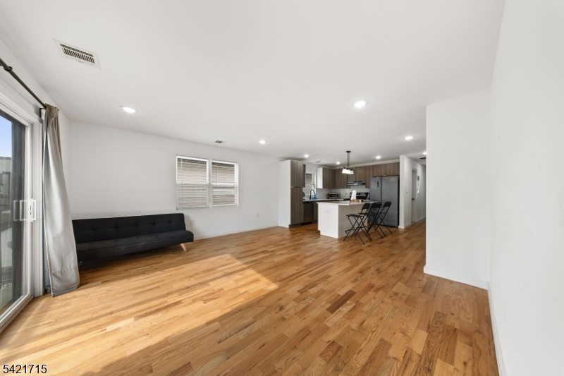 735 Seaport Drive, Unit 2 Elizabeth, NJ 07201 - Photo 8 of 28 a living room with stainless steel appliances furniture and a kitchen view