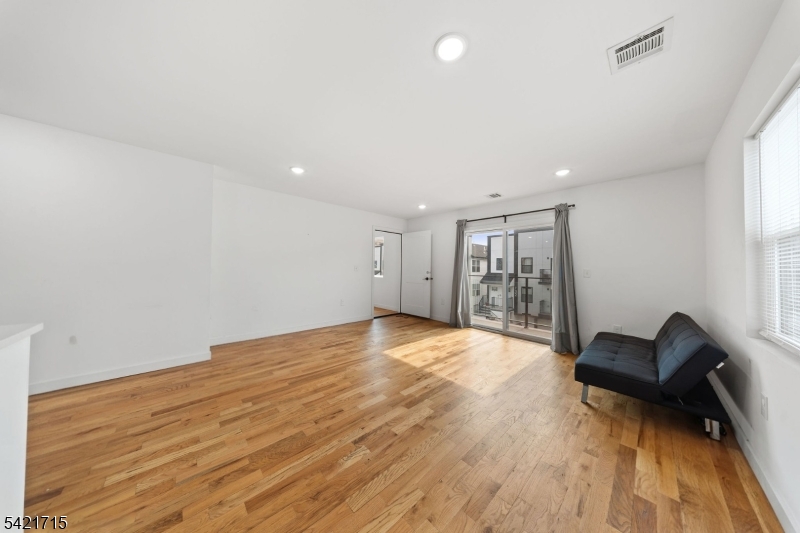 735 Seaport Drive, Unit 2 Elizabeth, NJ 07201 - Photo 9 of 28 a view of empty room with wooden floor and fan