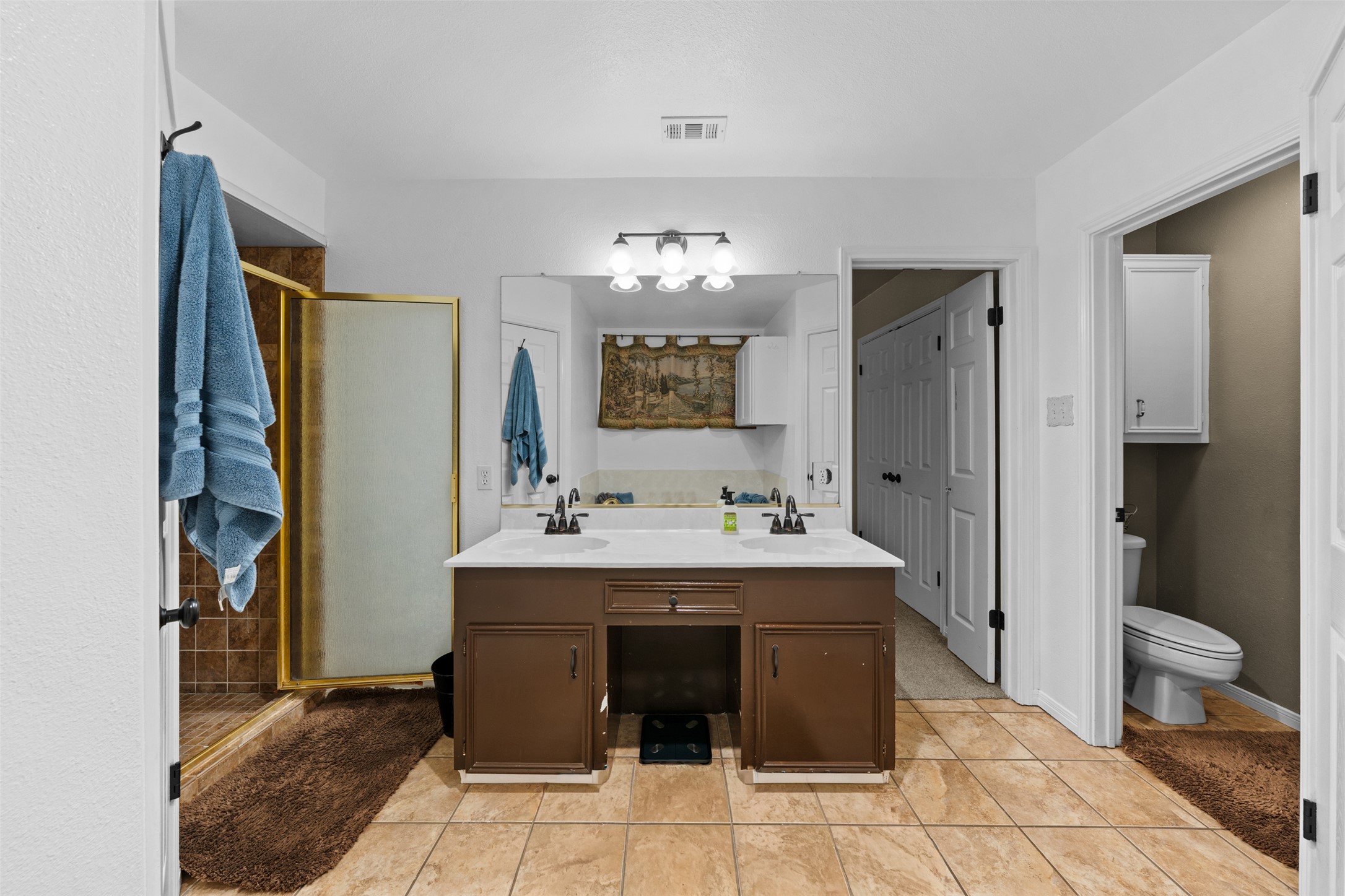 1512 Panther Loop Pflugerville, TX 78660 - Photo 18 of 40 Dual vanity offers convenience, complemented by a tiled shower and an adjacent private water closet.