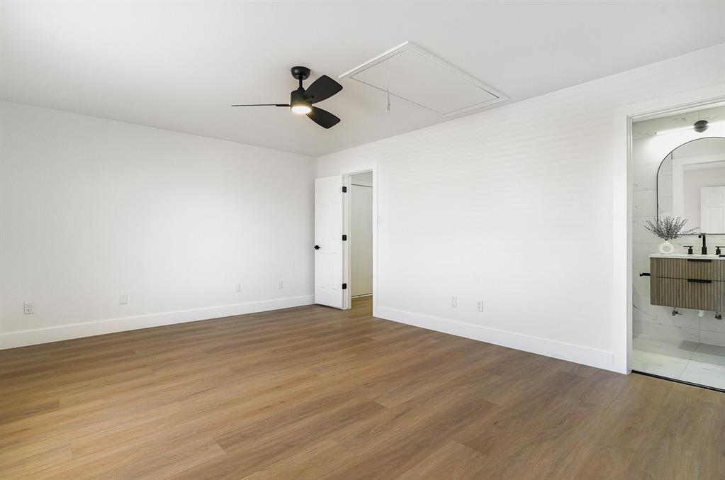 7524 Aberdon Road Dallas, TX 75252 - Photo 22 of 39 Spare room with ceiling fan, wood finished floors, attic access, and baseboards
