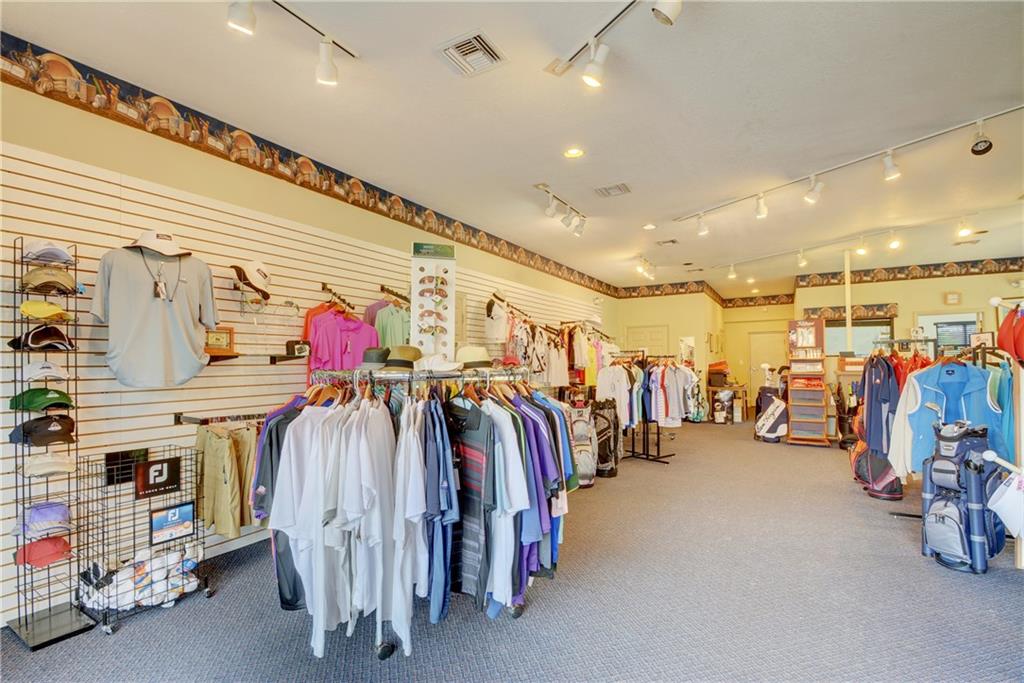 5675 Southeast Miles Grant Road Stuart, FL 34997 - Photo 85 of 93 a view of walk in closet with clothes and shoes