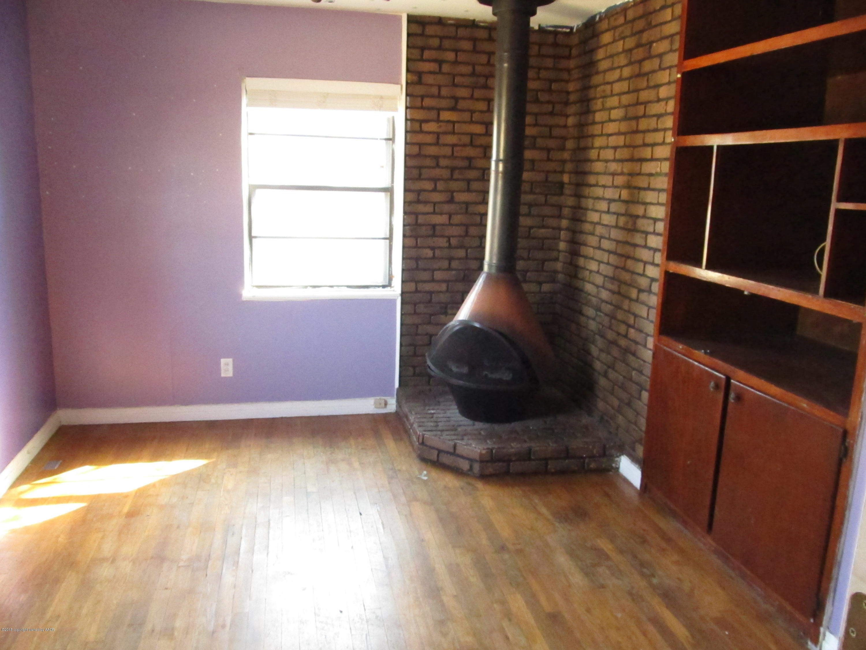 4420 South Travis Street Amarillo, TX 79110 - Photo 3 of 9 a view of a room with wooden floor and a window