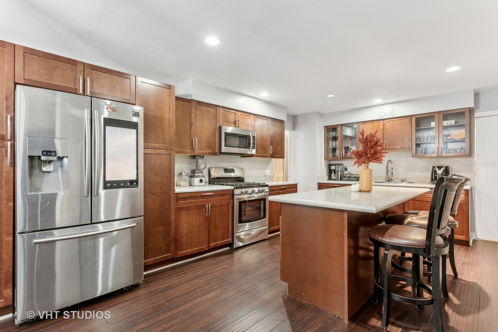 79 Sheffield Road Montgomery, IL 60538 - Photo 9 of 20 a kitchen with stainless steel appliances granite countertop a refrigerator a stove a sink a dining table and chairs