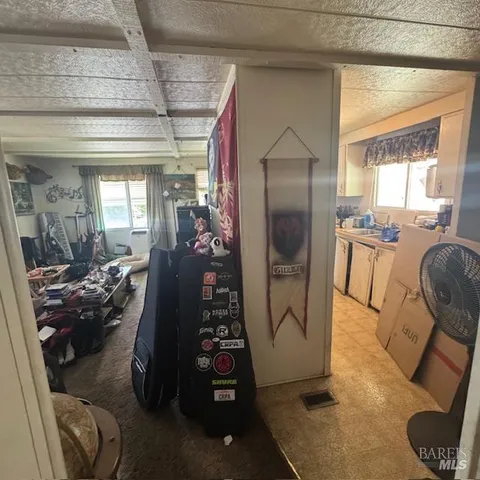 a bathroom with a toilet and shower curtain
