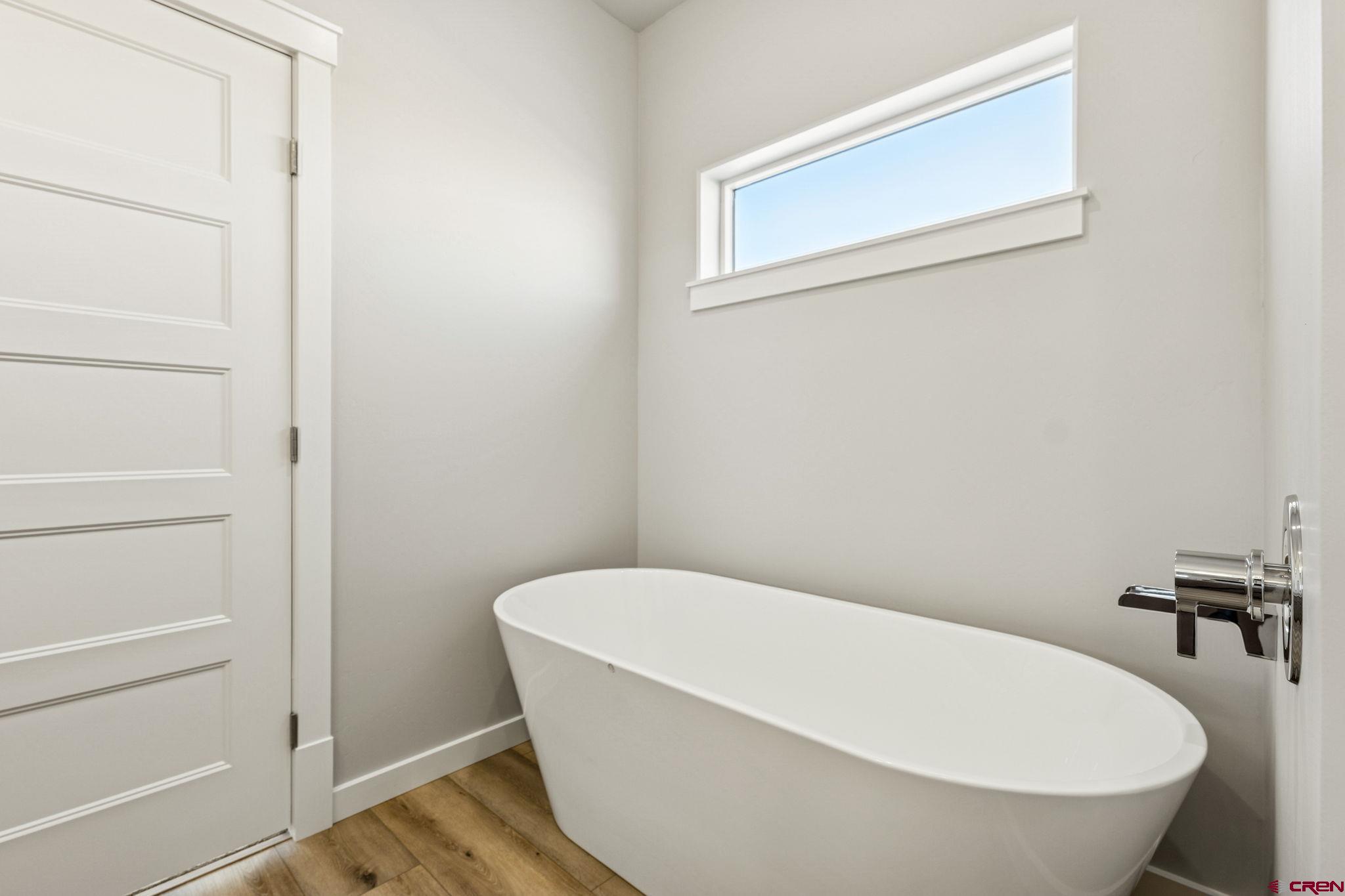 2223 Golf Course Lane Cortez, CO 81321 - Photo 11 of 26 a white bath tub sitting in a bathroom
