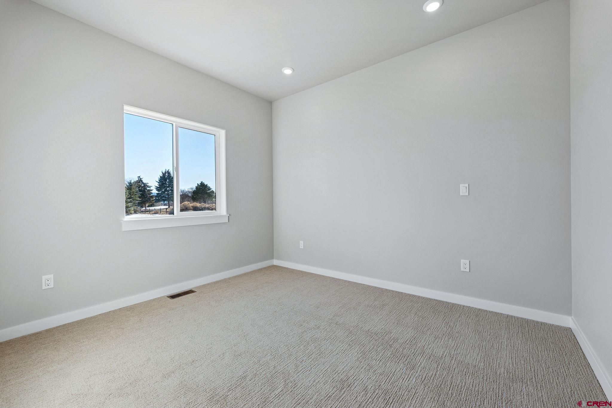 2223 Golf Course Lane Cortez, CO 81321 - Photo 17 of 26 an empty room with windows