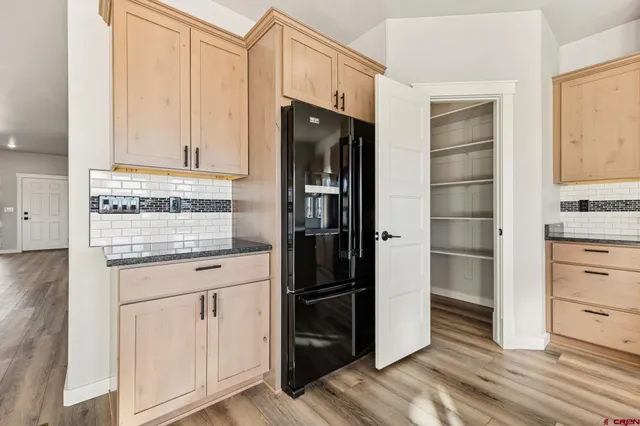 a kitchen with stainless steel appliances a refrigerator and cabinets