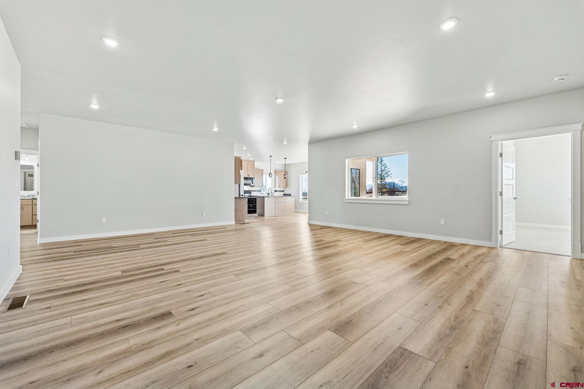 2223 Golf Course Lane Cortez, CO 81321 - Photo 7 of 26 a view of empty room with wooden floor and fan