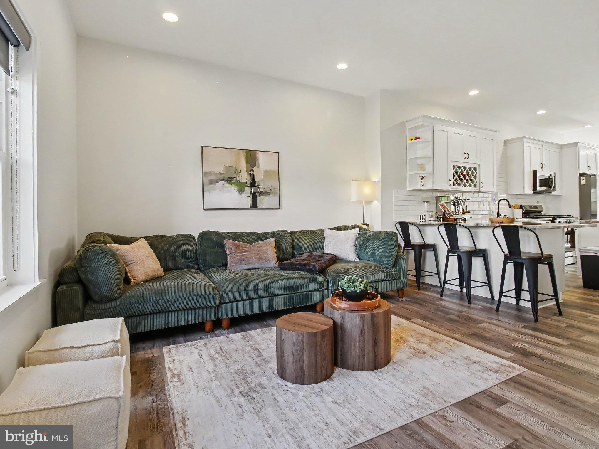 3915 Roland Avenue Baltimore, MD 21211 - Photo 3 of 26 a living room with furniture and wooden floor