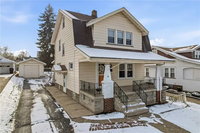 a front view of a house with sitting area