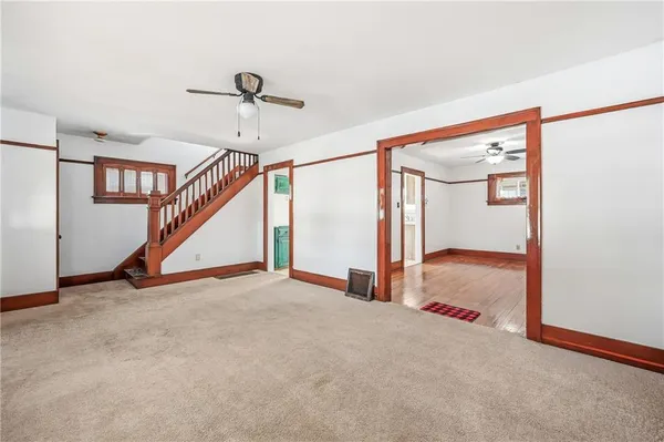a view of a livingroom with hardwood floor and a ceiling fan