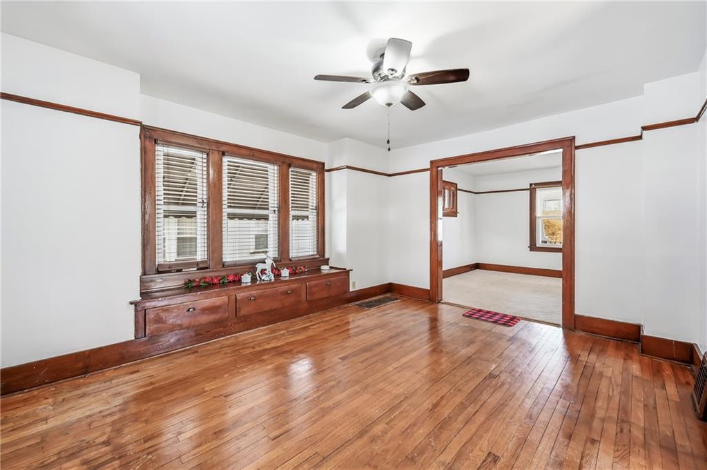 486 Tamplin Street Sharon, PA 16146 - Photo 15 of 37 a view of a livingroom with hardwood floor and a ceiling fan