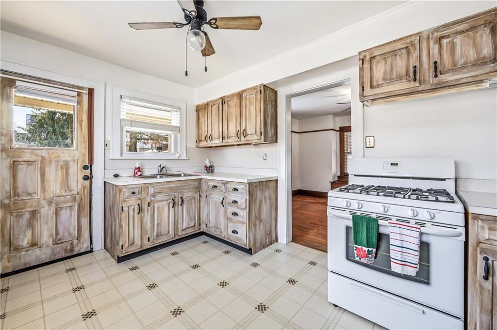 486 Tamplin Street Sharon, PA 16146 - Photo 17 of 37 a kitchen with stainless steel appliances granite countertop a stove a sink and a refrigerator