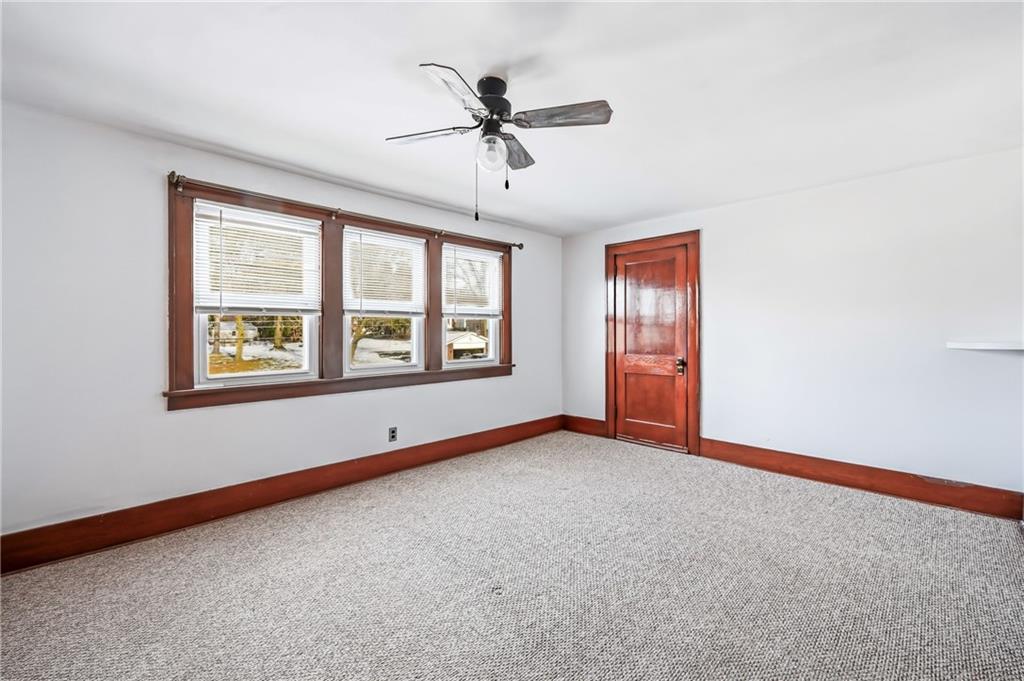 486 Tamplin Street Sharon, PA 16146 - Photo 21 of 37 an empty room with chandelier fan and windows