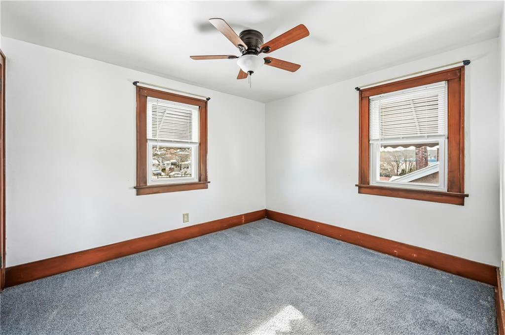 486 Tamplin Street Sharon, PA 16146 - Photo 26 of 37 an empty room with window and ceiling fan