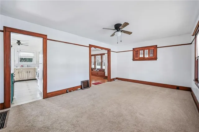 a room with pool table and large windows