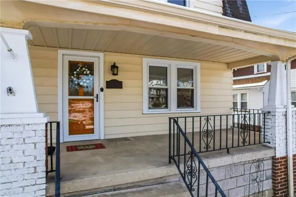 a view of front door of house with stairs