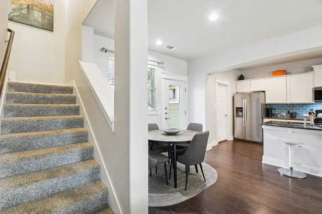a view of a dining room with furniture and wooden floor