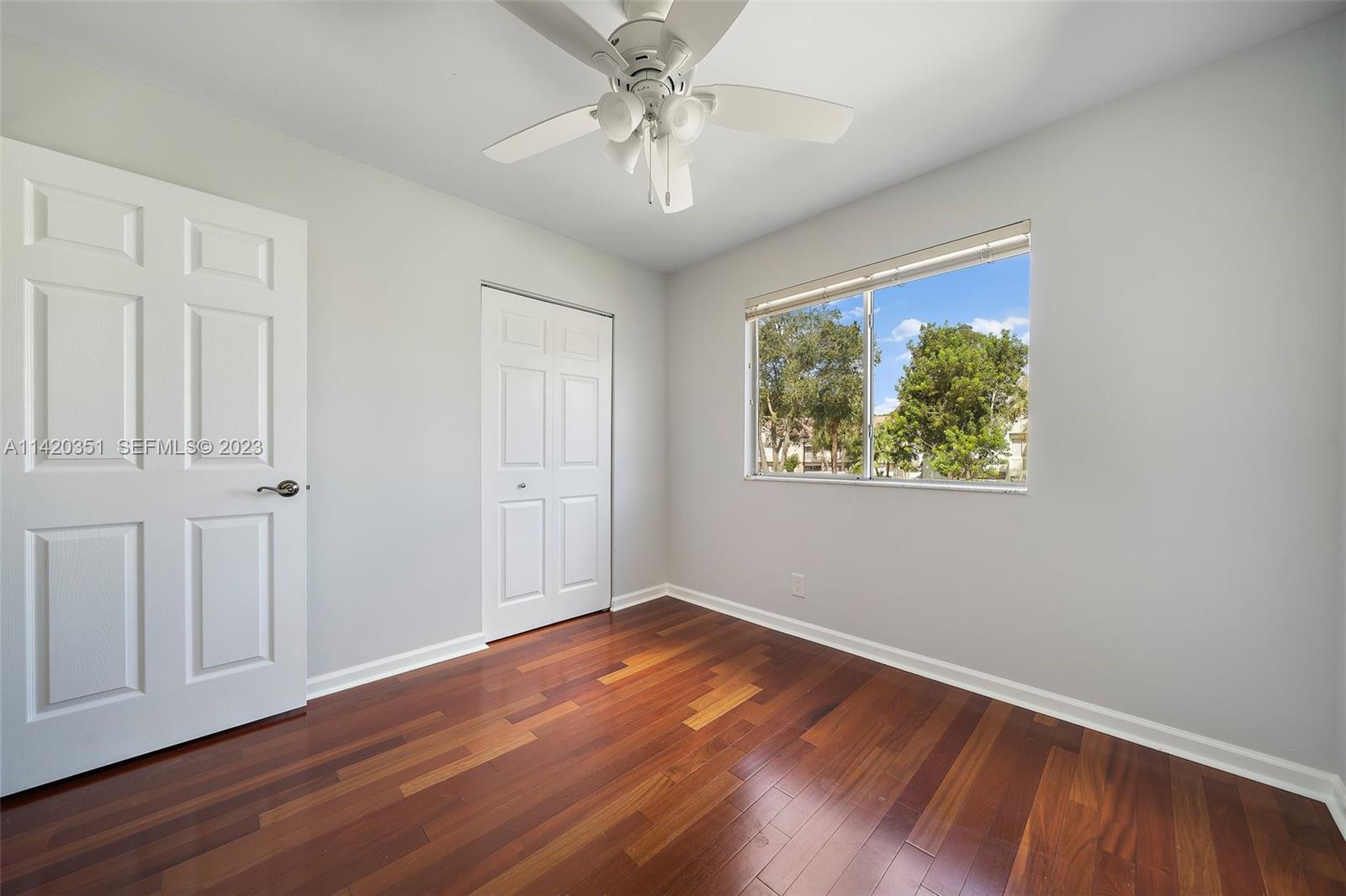 6351 Riverwalk Lane, Unit 4 Jupiter, FL 33458 - Photo 28 of 40 a view of empty room with wooden floor and fan