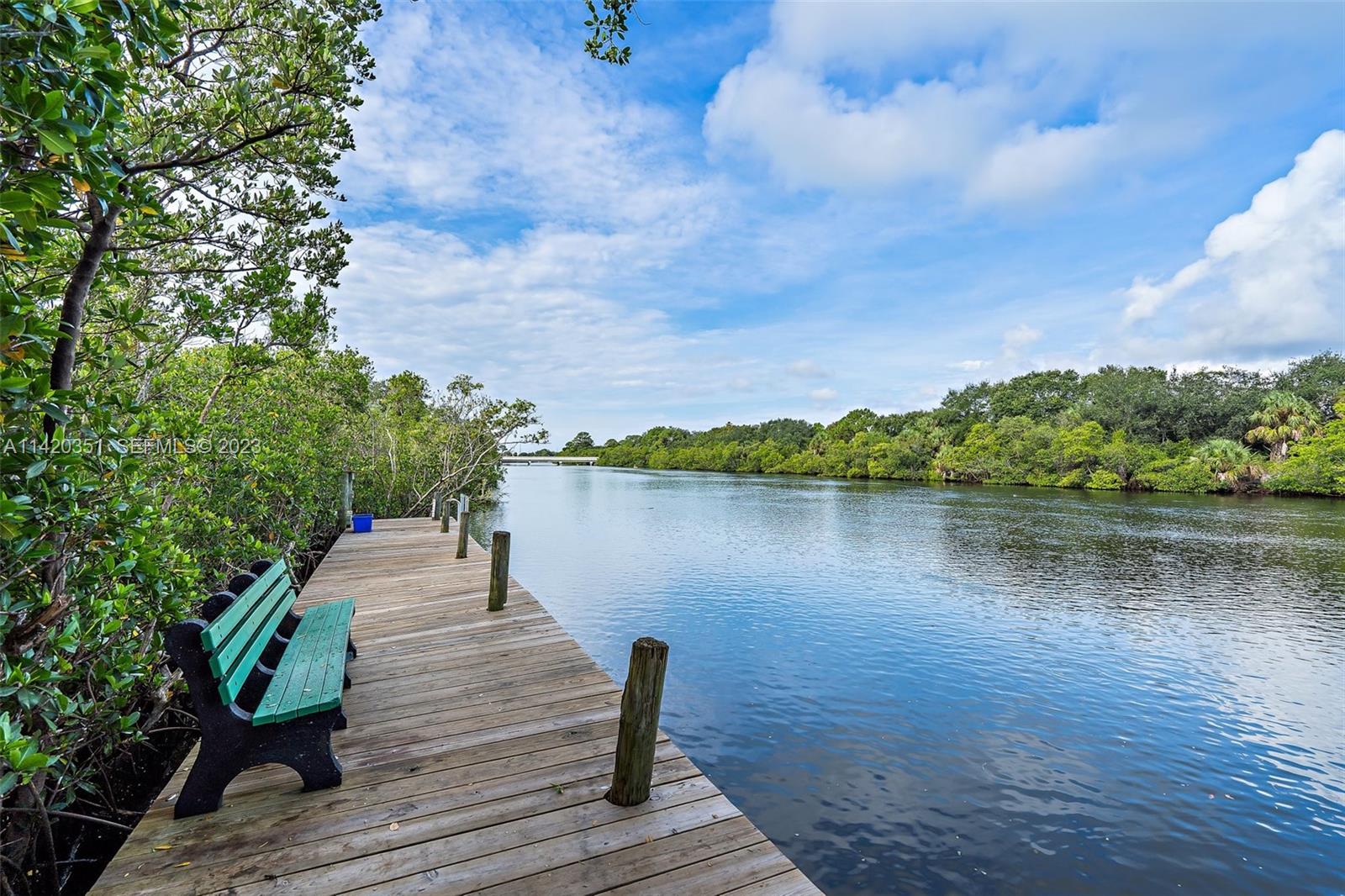 6351 Riverwalk Lane, Unit 4 Jupiter, FL 33458 - Photo 35 of 40 a wooden pier with boats in a lake