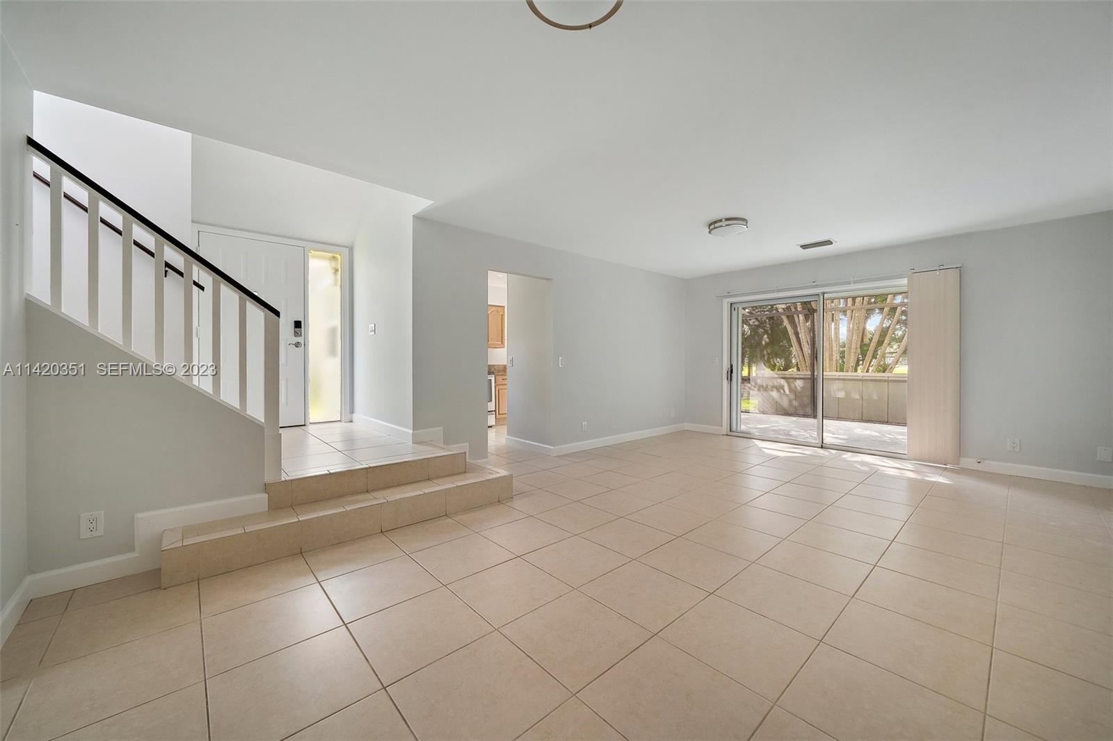 6351 Riverwalk Lane, Unit 4 Jupiter, FL 33458 - Photo 6 of 40 a view of an empty room with glass door
